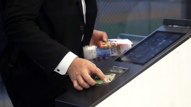 A customer uses a Suica rail commuter pass to purchase items at the cashierless kiosk, powered by Signpost Corp. on the East Japan Railway Co. (JR East) Akabane Station platform in Tokyo, Japan, on Thursday, Oct. 25, 2018. Cameras and artificial-intelligence software developed by Signpost Corp. track merchandise and purchases. Company founder Yasushi Kambara calls it the “Super Wonder Register,” and says his product can be installed in any store. Photographer: Kiyoshi Ota/Bloomberg