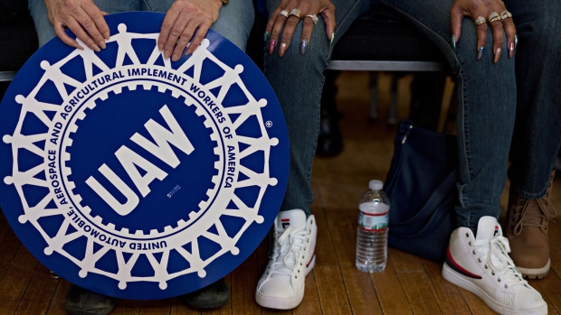 An attendee holds a United Auto Workers (UAW) sign during a campaign rally for Randy Bryce, Democratic U.S. Representative candidate from Wisconsin, not pictured, in Racine, Wisconsin, U.S., on Saturday, Feb. 24, 2018. Bryce, a union ironworker, is hoping to defeat Republican U.S. House Speaker Paul Ryan to represent Wisconsin's 1st district. Photographer: Daniel Acker/Bloomberg