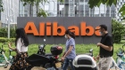 Pedestrians wearing protective masks walk past the Alibaba Group Holding Ltd. logo displayed in front of the company's building in Beijing, China, on Wednesday, Aug. 19, 2020. U.S. President Donald Trump is threatening to slap TikTok-style sanctions on more Chinese companies and Alibaba Group Holding Ltd., as the largest of them all, may be next in line. Photographer: Gilles Sabrie/Bloomberg