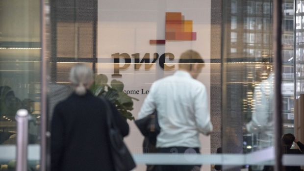 Signage at the lobby of PricewaterhouseCoopers Australia office in Sydney, Australia, on Thursday, May 25, 2023. The Australian government has referred a PwC tax scandal to the police and asked them to consider a criminal investigation as political scrutiny mounts. Photographer: Brent Lewin/Bloomberg