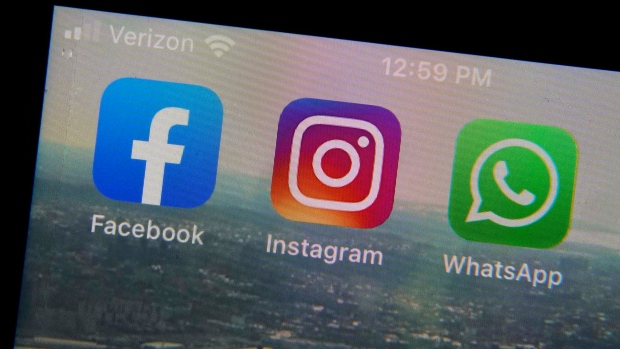 Facebook, Instagram, WhatsApp logos on phone