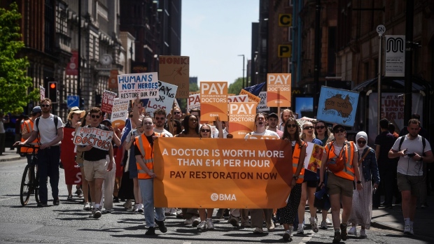 Junior doctors protest during the second day of strike action in Manchester, UK, on June 15. Photographer: Mary Turner/Bloomberg